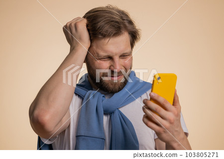 Sad man use smartphone typing browsing loses becoming surprised sudden lottery result bad fortune 103805271