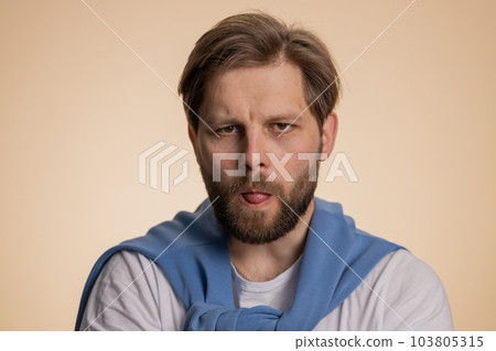 Cheerful funny bully caucasian man showing tongue making silly faces, fooling around, joking teasing 103805315
