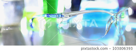 Transparent glasses and chemical liquids in test tubes in laboratory 103806393
