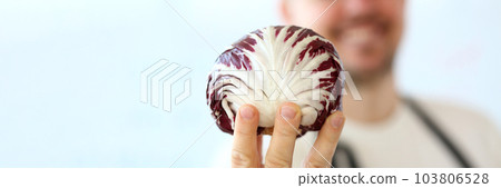 Smiling chef holding red cabbage. Benefits of vegetarian food 103806528