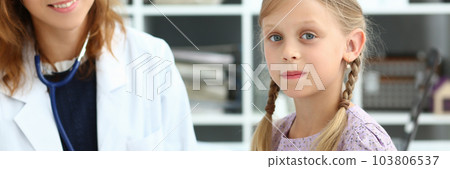 Friendly female pediatrician little girl health in clinic Friendly female pediatrician little girl health in clinic 103806537