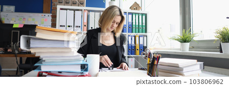 Businesswoman or secretary in office and stamping document 103806962