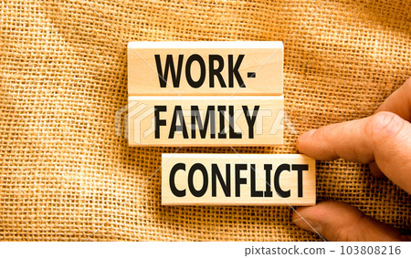 Work-family conflict symbol. Concept words Work-family conflict on wooden block on a beautiful canvas table canvas background. Businessman hand. Business work-family conflict concept. Copy space. Work-family conflict symbol. Concept words Work-family conflict on wooden block on a beautiful canvas table canvas background. Businessman hand. Business work-family conflict concept. Copy space. 103808216