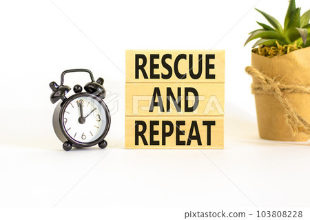 Rescue and repeat symbol. Concept words Rescue and repeat on wooden block on a beautiful white table white background. Black alarm clock. Business rescue and repeat concept. Copy space. 103808228
