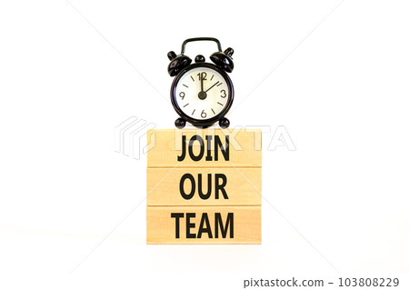Join our team symbol. Concept words Join our team on wooden block on a beautiful white table white background. Black alarm clock. Business and join our team concept. Copy space. 103808229
