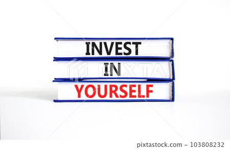 Invest in yourself symbol. Concept words Invest in yourself on books on a beautiful white table white background. Business and Invest in yourself concept. Copy space. 103808232
