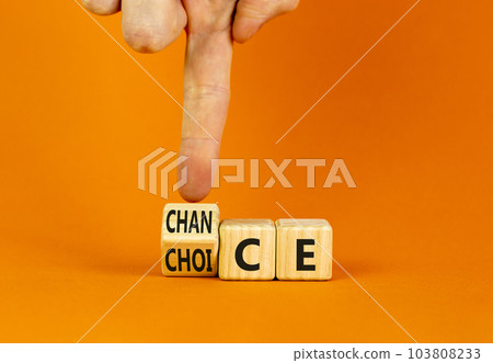 Choice and chance symbol. Businessman turns wooden cubes and changes the word Choice to Chance. Beautiful orange table orange background. Business choice and chance concept. Copy space. 103808233
