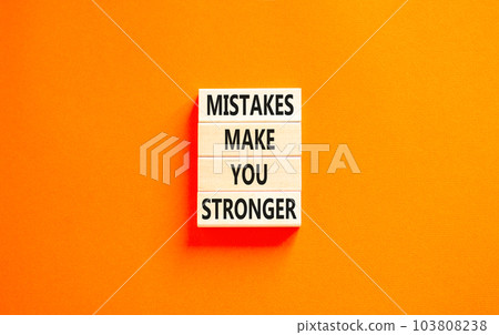 Mistake make stronger symbol. Concept words Mistakes make you stronger on wooden blocks. Beautiful orange table orange background. Business mistake make stronger concept. Copy space. 103808238