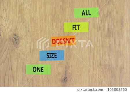 One size does not fit all symbol. Concept words One size does not fit all on colored paper. Beautiful wooden table wooden background. One size does not fit all business concept. Copy space. 103808260