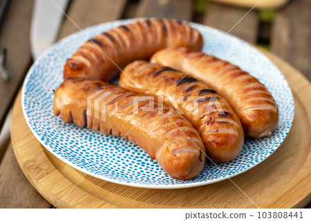 grilled sausages on plate 103808441