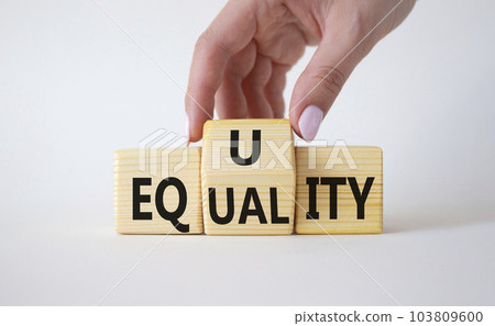 Equity and Equality symbol. Businessman hand turns wooden cubes and changes the word Equality to Equity. Beautiful white background. Equity and Equality and business concept. Copy space 103809600