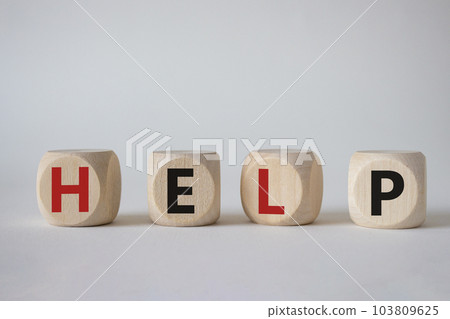 Help symbol. Concept word help on wooden cubes. Beautiful white background. Business and help concept. Copy space. Help symbol. Concept word help on wooden cubes. Beautiful white background. Business and help concept. Copy space. 103809625