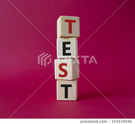 Test symbol. Concept word Test on wooden cubes. Beautiful red background. Business and Test concept. Copy space. Test symbol. Concept word Test on wooden cubes. Beautiful red background. Business and Test concept. Copy space. 103810046
