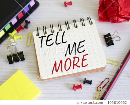 Tell me more symbol. Concept words Tell me more on wooden notebook. Beautiful wooden background. Business and Tell me more concept. Copy space. 103810062