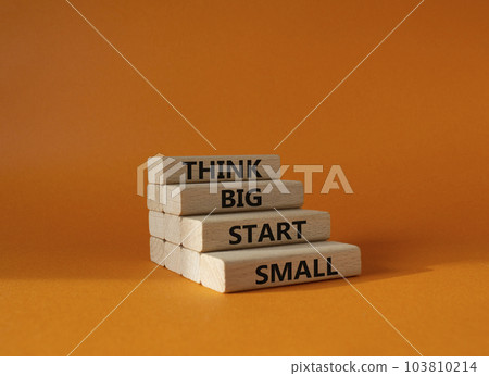 Think big start small symbol. Concept words Think big start small on wooden blocks. Beautiful orange background. Business and Think big start small concept. Copy space Think big start small symbol. Concept words Think big start small on wooden blocks. Beautiful orange background. Business and Think big start small concept. Copy space 103810214