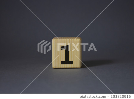 Number one symbol. Number 1 on wooden cubes. Beautiful grey background. Business and Number one concept. Copy space. 103810916
