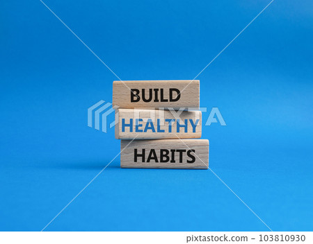 Healthy habits symbol. Concept word Build Healthy habits on wooden blocks. Beautiful blue background. Healthy lifestyle and Healthy habits concept. Copy space 103810930