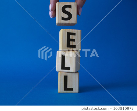 Sell symbol. Concept word Sell on wooden cubes. Businessman hand. Beautiful blue background. Business and Sell concept. Copy space. 103810972