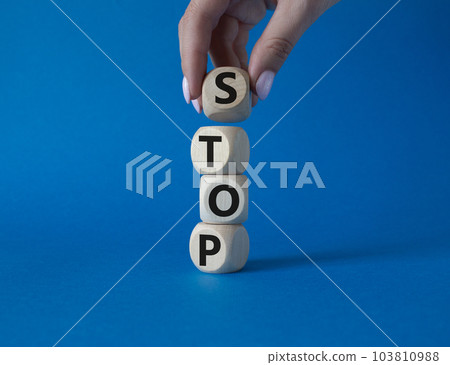 Stop symbol. Concept word Stop on wooden cubes. Businessman hand. Beautiful blue background. Business and Stop concept. Copy space. 103810988
