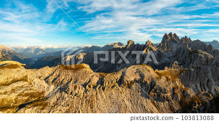 Captivating Aerial View of Tre Cime di Lavaredo's Mountain Massif Bathed in the Warm Glow of Sunset Captivating Aerial View of Tre Cime di Lavaredo's Mountain Massif Bathed in the Warm Glow of Sunset 103813088