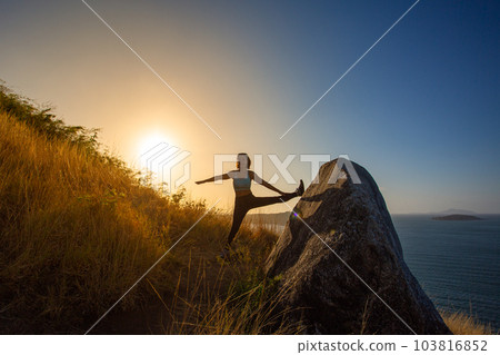 .Two women exercising on the top of a mountain..On the hilltop filled with the smell of the sea, .making it the perfect place to exercise relax and enjoy the scenery..golden sunrise shines background. .Two women exercising on the top of a mountain..On the hilltop filled with the smell of the sea, .making it the perfect place to exercise relax and enjoy the scenery..golden sunrise shines background. 103816852
