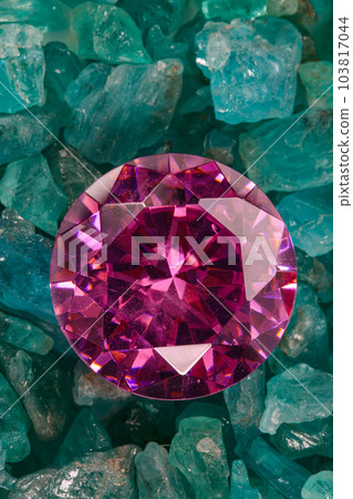 amethyst diamonds diamond on placed on a pile of raw sky blue gemstones..jewelry are lovely present for valentine day.colorful raw stone background.lived a life of luxury. 103817044