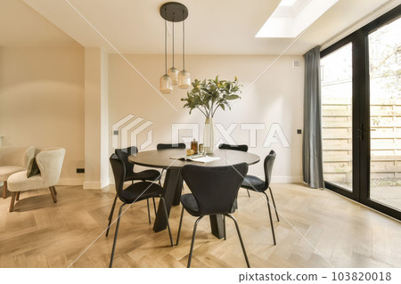 a dining room with wood flooring and glass doors leading out to the patio area, which is also open a dining room with wood flooring and glass doors leading out to the patio area, which is also open 103820018