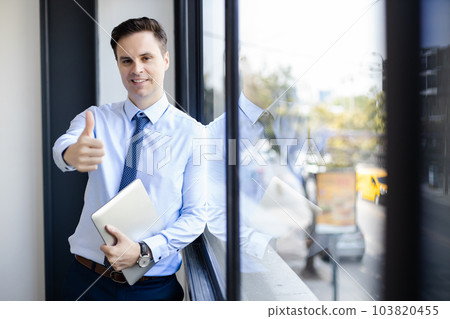 Portrait of Happy success businessman holding laptop gesture thumb up. Portrait of Happy success businessman holding laptop gesture thumb up. 103820455