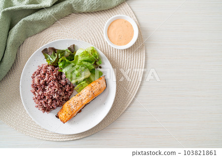 grilled salmon fillet steak with rice berry and vegetable 103821861