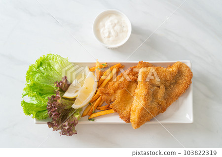 fish and chips - fried fish fillet with potatoes chips fish and chips - fried fish fillet with potatoes chips 103822319