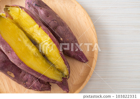 Grilled or baked Japanese sweet potatoes on wood plate Grilled or baked Japanese sweet potatoes on wood plate 103822331