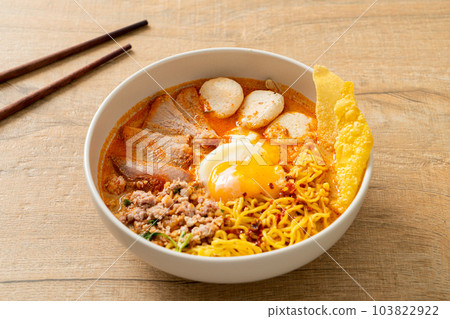 egg noodles with pork and meatball in spicy soup 103822922