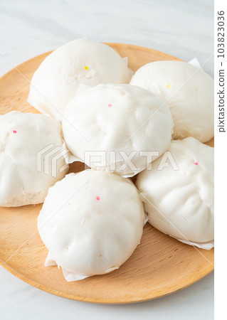 stuffed steamed bun on wood plate stuffed steamed bun on wood plate 103823036