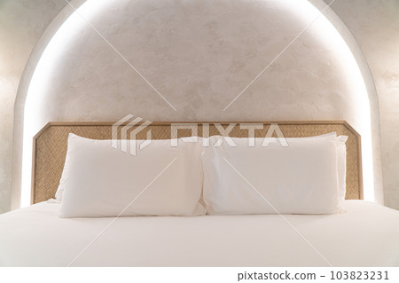 comfortable white pillows on bed 103823231
