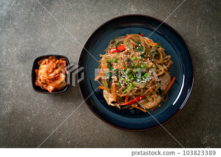 japchae or stir-fried Korean vermicelli noodles with vegetables and pork topped with white sesame 103823389