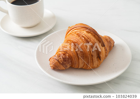 fresh croissant on white plate 103824039