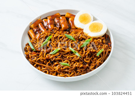 Jjajang Rabokki - Korean instant noodles or Ramyeon with Korean rice cake or Tteokbokki and egg in black bean sauce 103824451