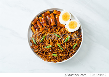 Jjajang Rabokki - Korean instant noodles or Ramyeon with Korean rice cake or Tteokbokki and egg in black bean sauce 103824452
