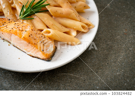 salmon with penne pasta cream sauce 103824482