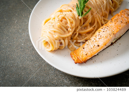 grilled salmon with spaghetti creamy tomato sauce 103824489
