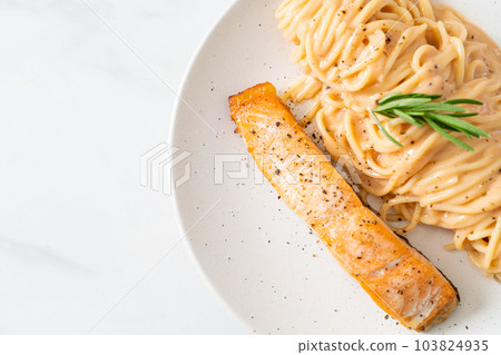 grilled salmon with spaghetti creamy tomato sauce 103824935