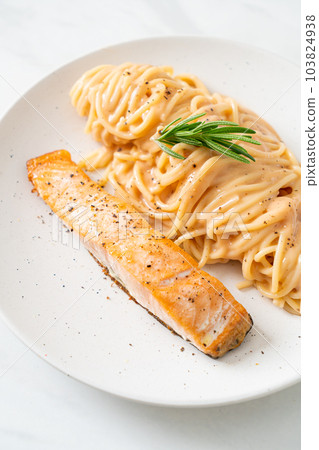 grilled salmon with spaghetti creamy tomato sauce 103824938