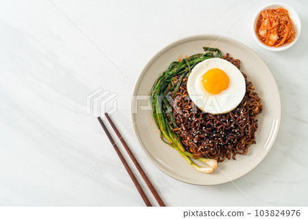dried Korean spicy black sauce instant noodles with fried egg and kimchi 103824976