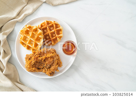 fried chicken waffle with honey or maple syrup 103825014
