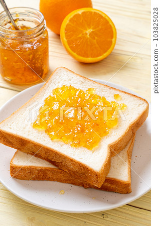 Slices of bread with orange jam 103825028