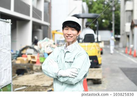 Young male worker with folded arms working at construction site 103825830
