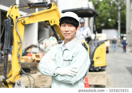 Young male worker with folded arms working at construction site Young male worker with folded arms working at construction site 103825831