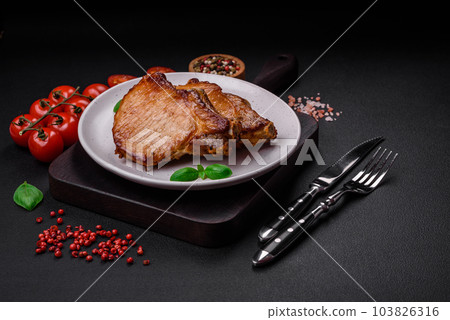 Delicious juicy pork or beef steak with salt, spices and herbs 103826316