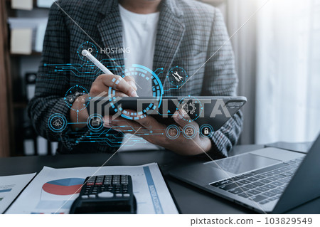 Male using computer, tablet and presses his finger on the virtual screen inscription Hosting on desk, Web hosting concept, Internet, business, digital technology concept. 103829549