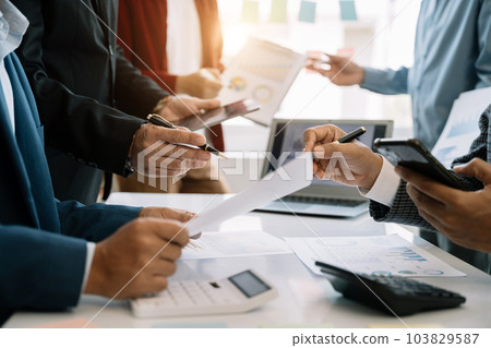 Teamwork process, Business team using a calculator to calculate the numbers of statistic business profits growth rate on documents graph data, desk in the office. Teamwork process, Business team using a calculator to calculate the numbers of statistic business profits growth rate on documents graph data, desk in the office. 103829587